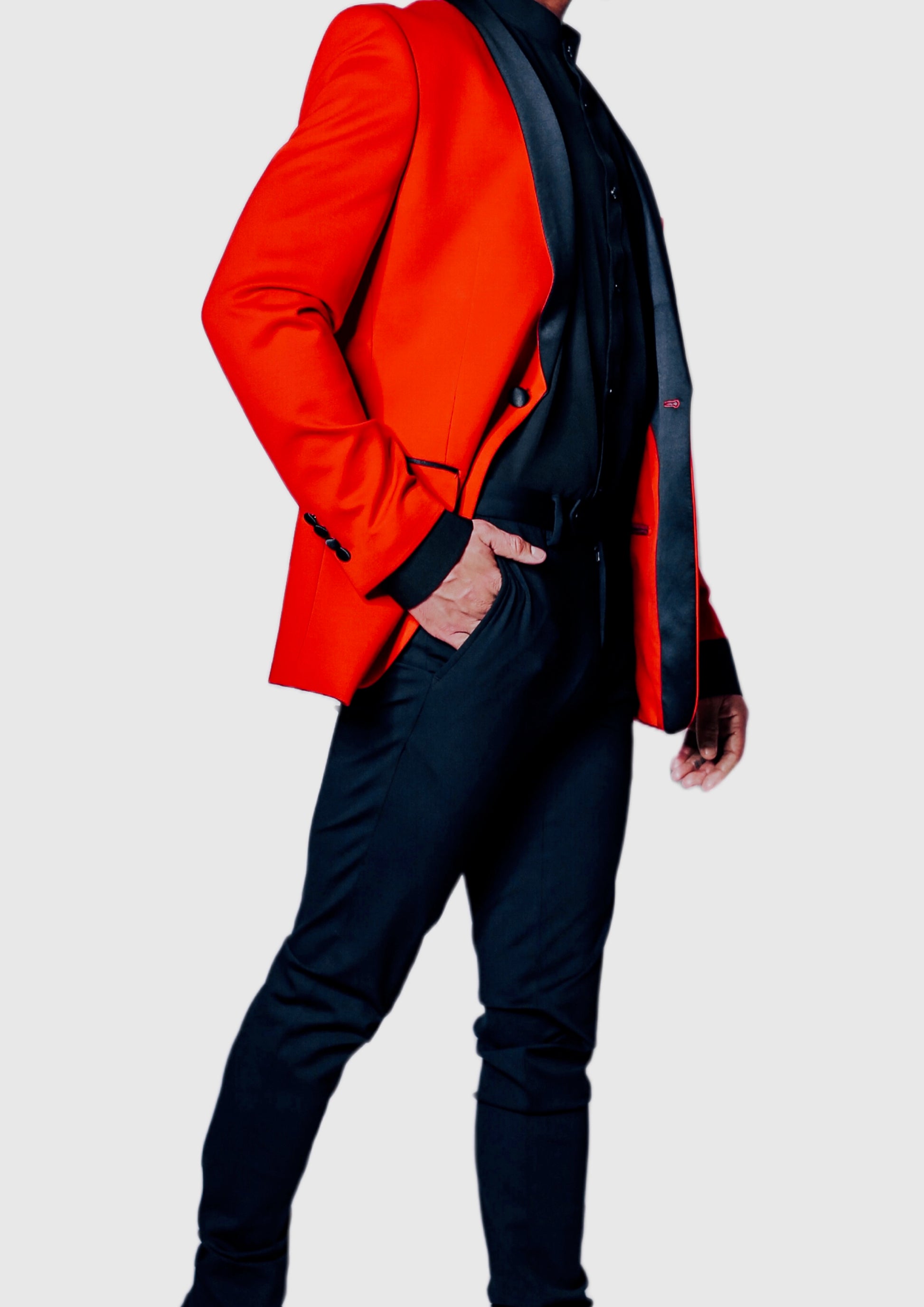 Confident male model in Flex Tailors red jacket and black trousers exuding style and sophistication