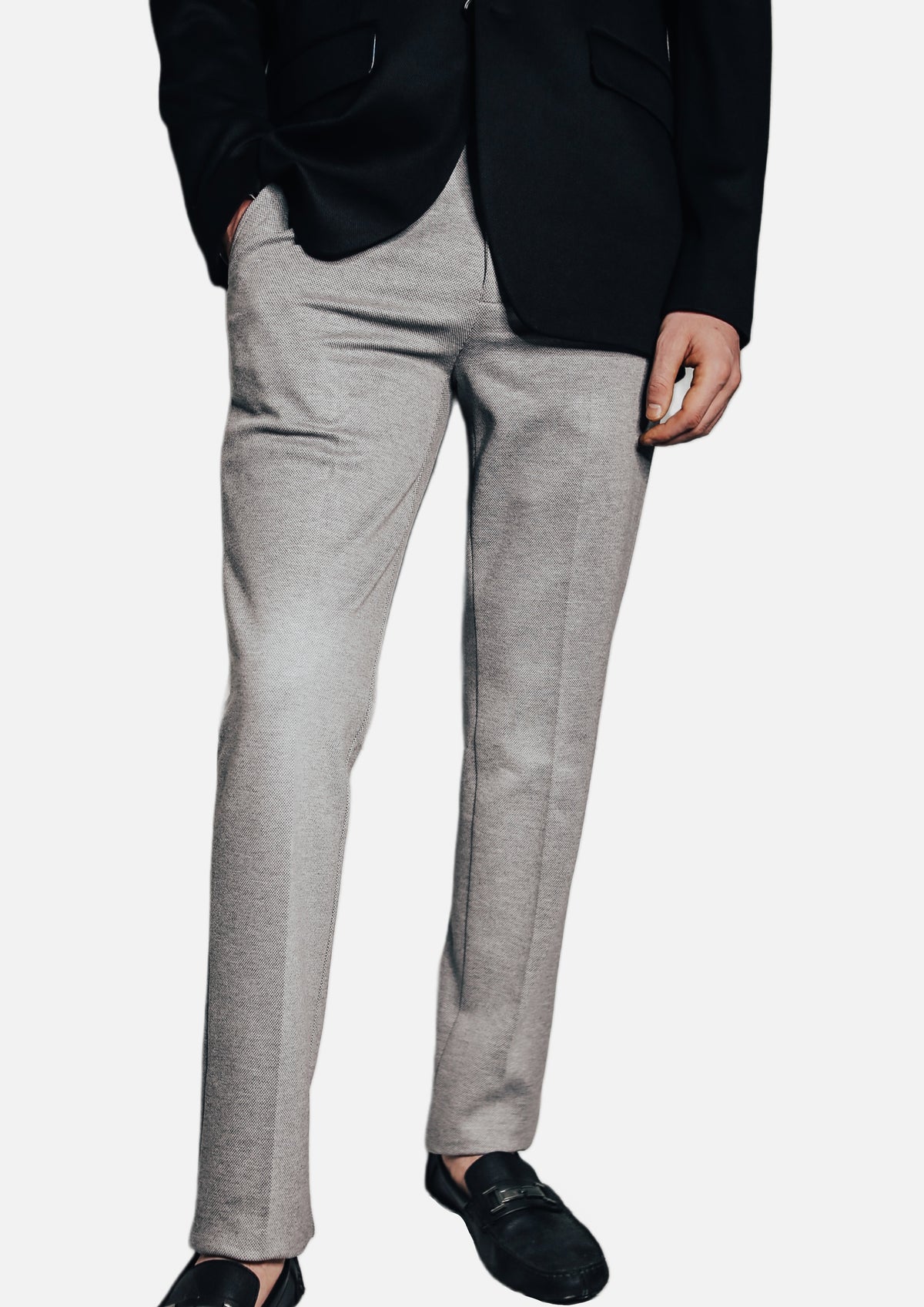 Men's Slim-Fit Stretch Gray Dress Pants on model under a black jacket, with black loafers