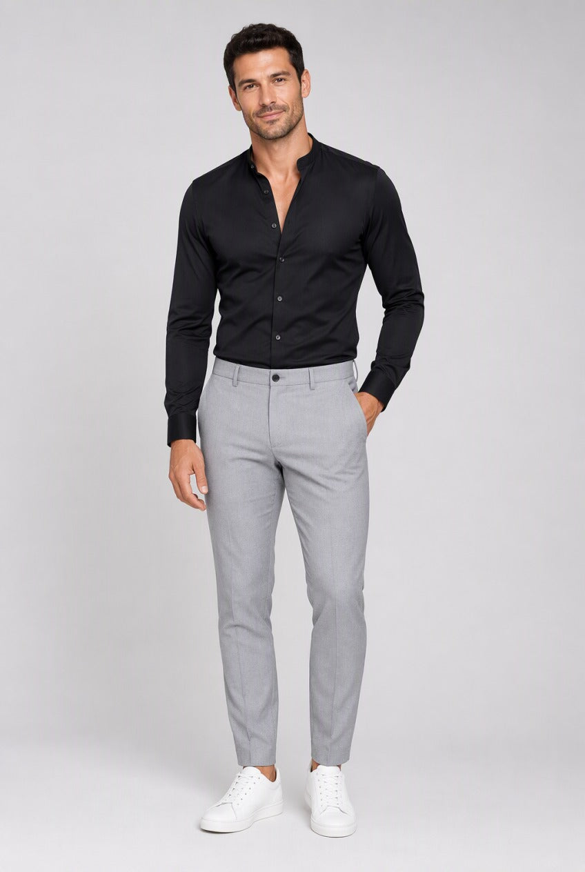 Men's Black Collarless Stretch Dress Shirt — on model with the top buttons open for a relaxed look, tucked into grey trousers with white sneakers