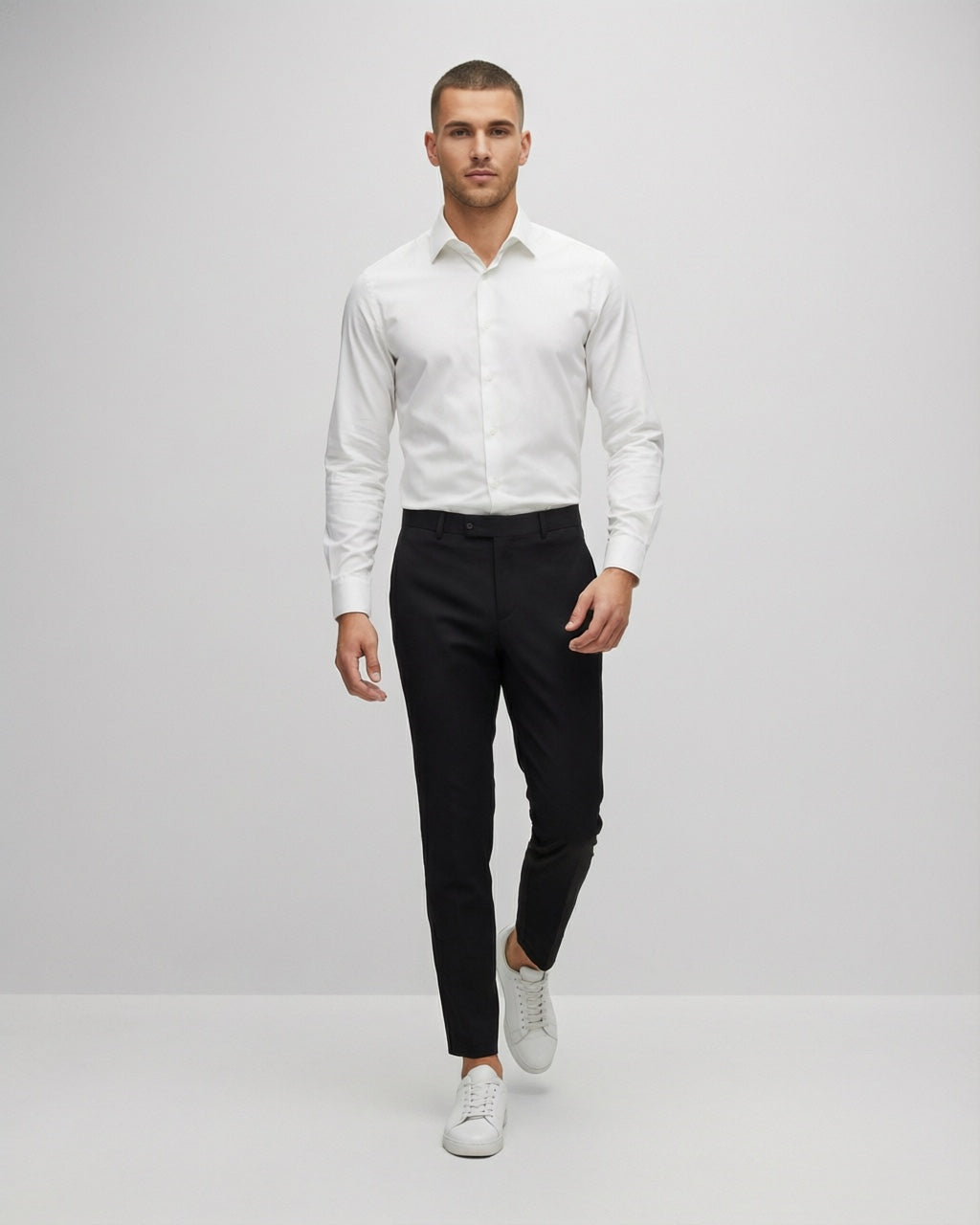 Men's Black Motion Stretch Dress Pants — on model with white shirt and white sneakers