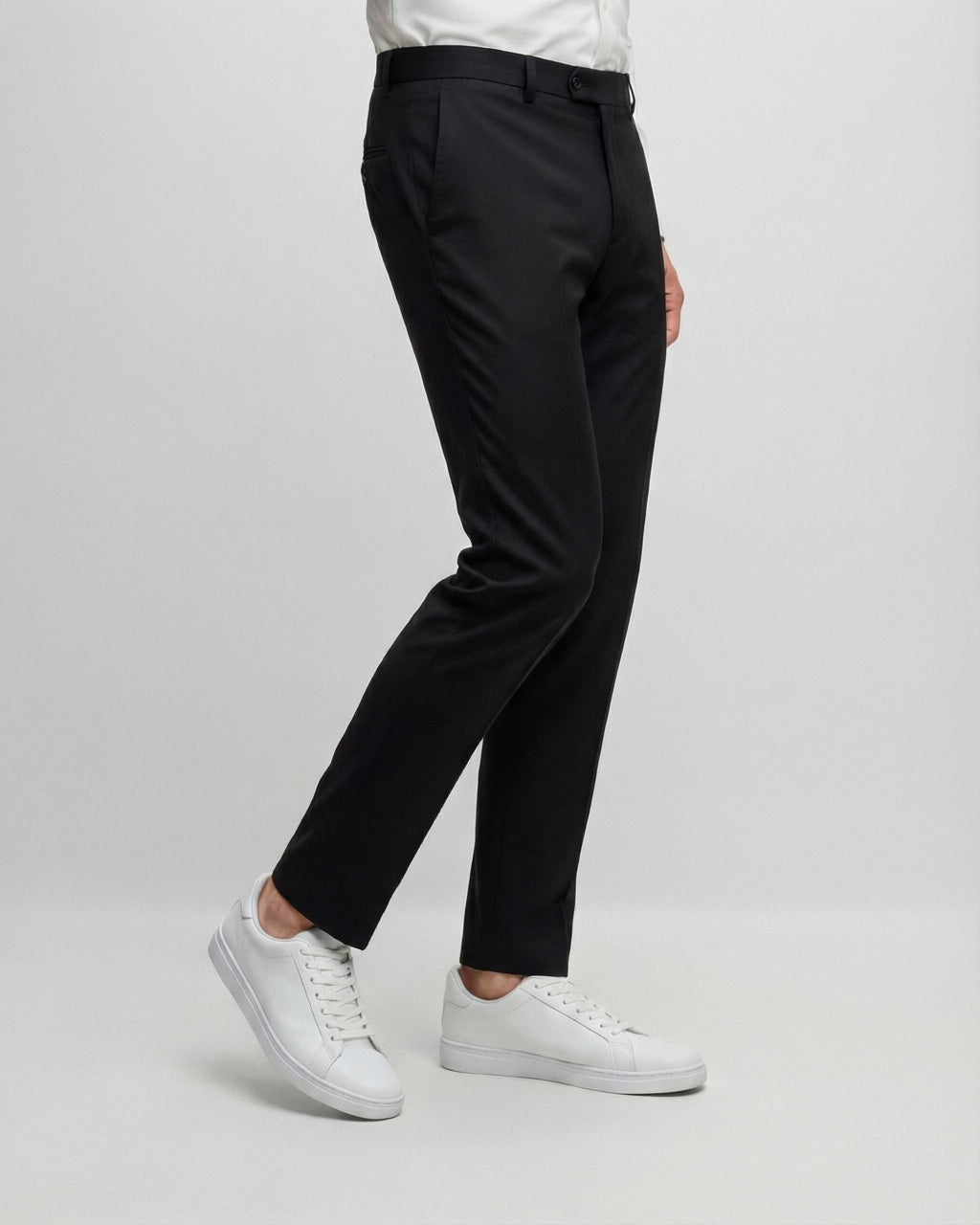 Men's Black Motion Stretch Dress Pants — trouser fit and hem detail with white sneakers