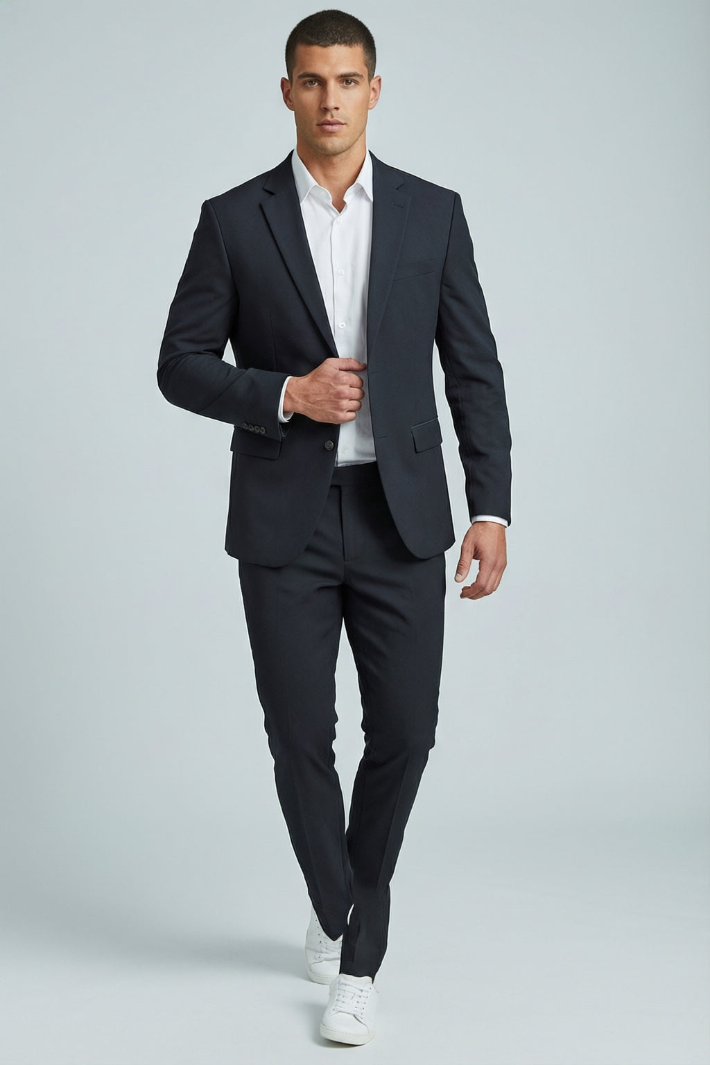 Men's Black Motion Stretch Suit — on model with white shirt and white sneakers