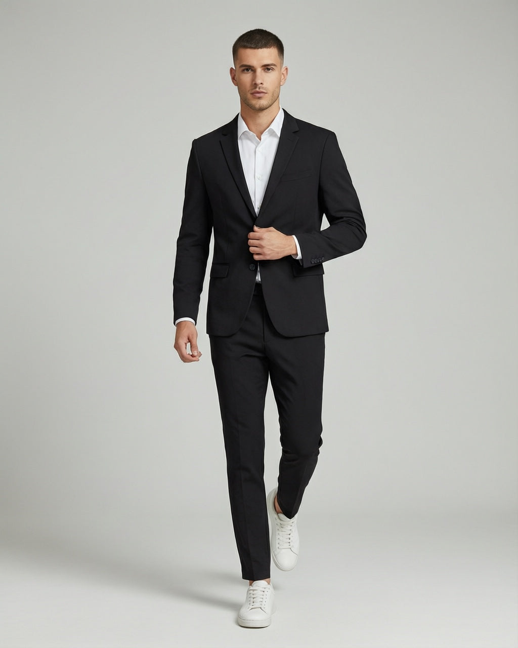 Men's Black Tailored Stretch Suit — on model with white shirt and white sneakers