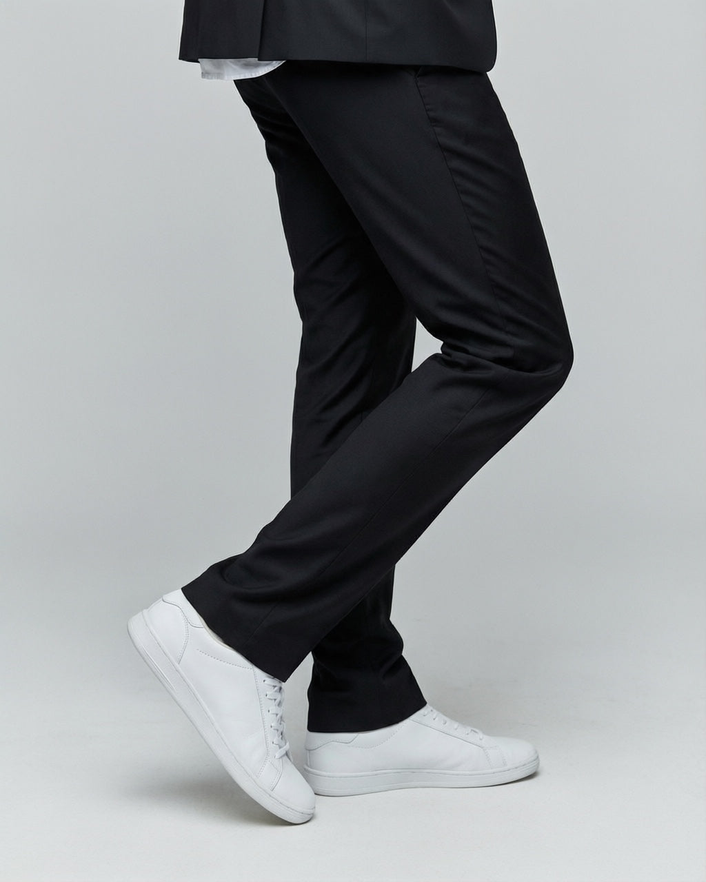 Men's Black Tailored Stretch Suit — trouser fit and hem detail with white sneakers