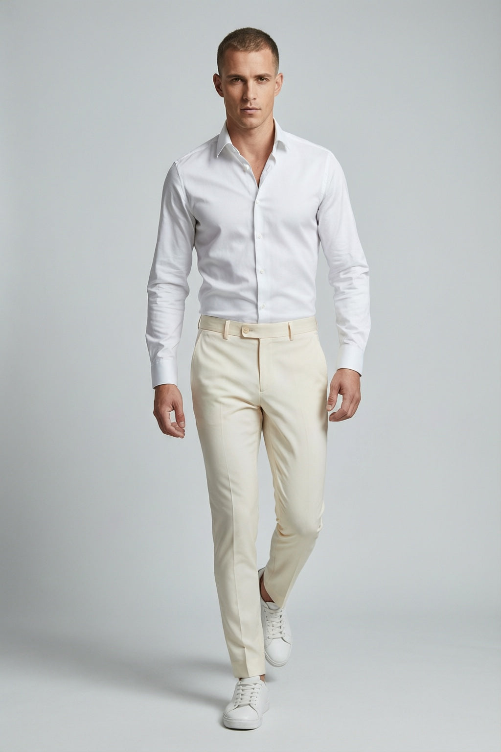 Men's Bone Motion Stretch Dress Pants — on model with white shirt and white sneakers