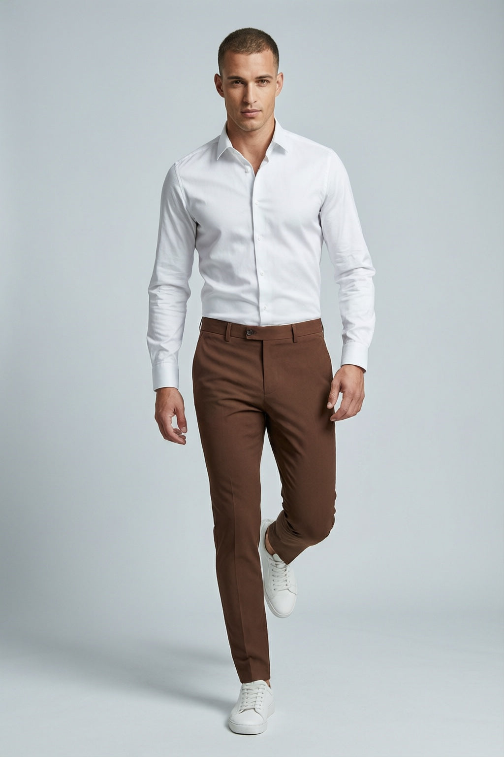 Men's Brown Motion Stretch Dress Pants — on model with white shirt and white sneakers