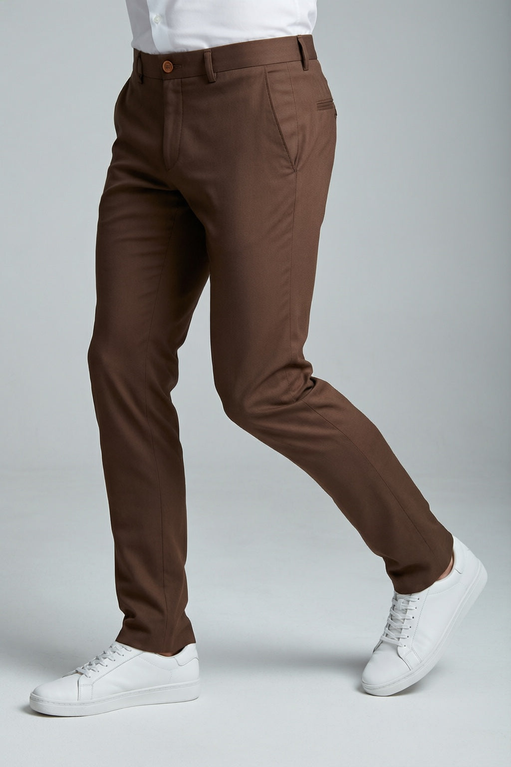 Men's Brown Motion Stretch Dress Pants — trouser fit and hem detail with white sneakers
