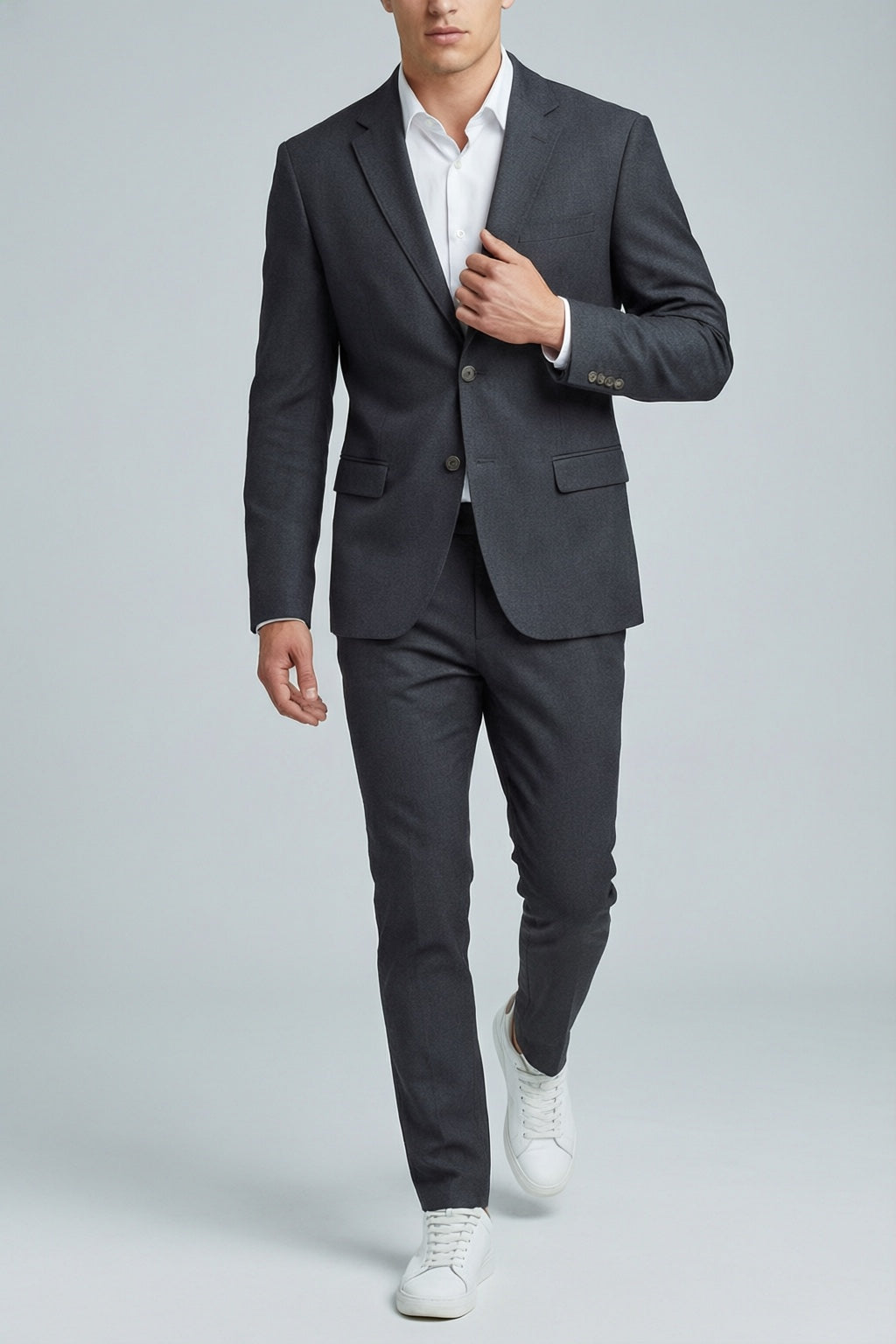 Men's Charcoal Motion Stretch Suit — on model with white shirt and white sneakers