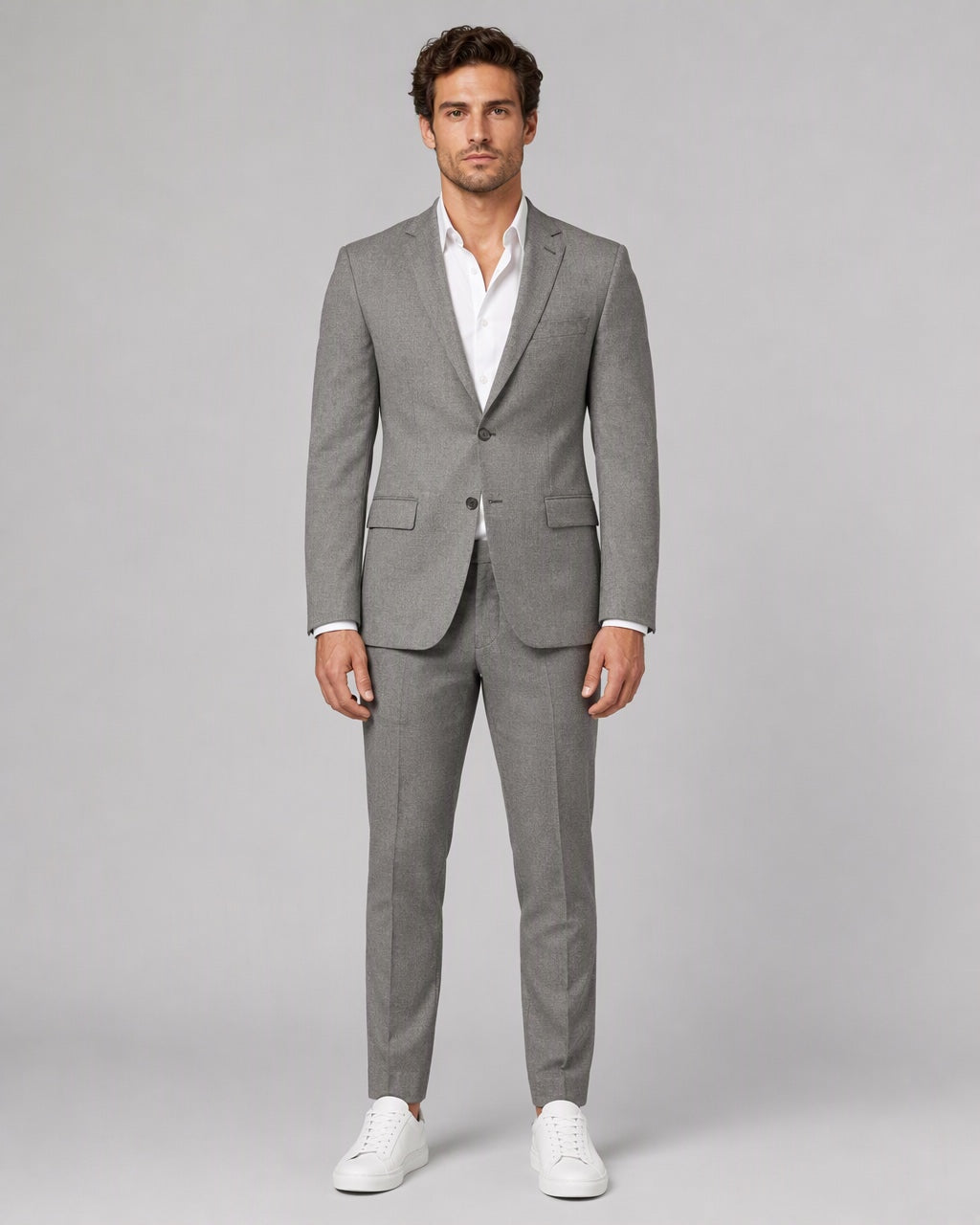 Men's Slim-Fit Heather Gray Stretch Suit on model, full-length front view over a white open-collar shirt with white sneakers
