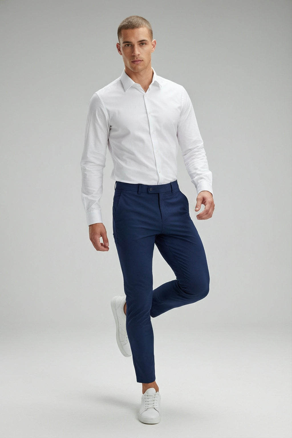 Men's Navy Motion Stretch Dress Pants — on model with white shirt and white sneakers