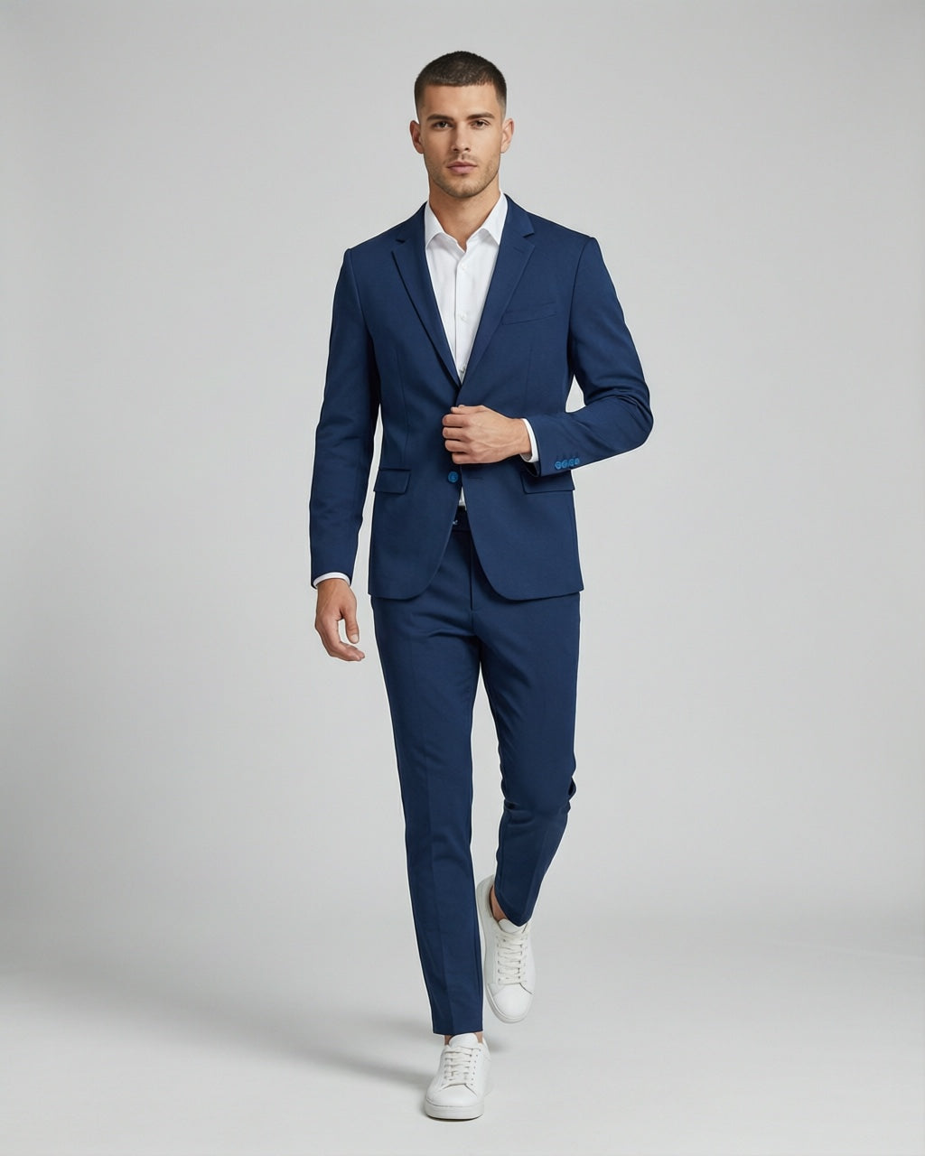 Men's Navy Motion Stretch Suit — on model with white shirt and white sneakers