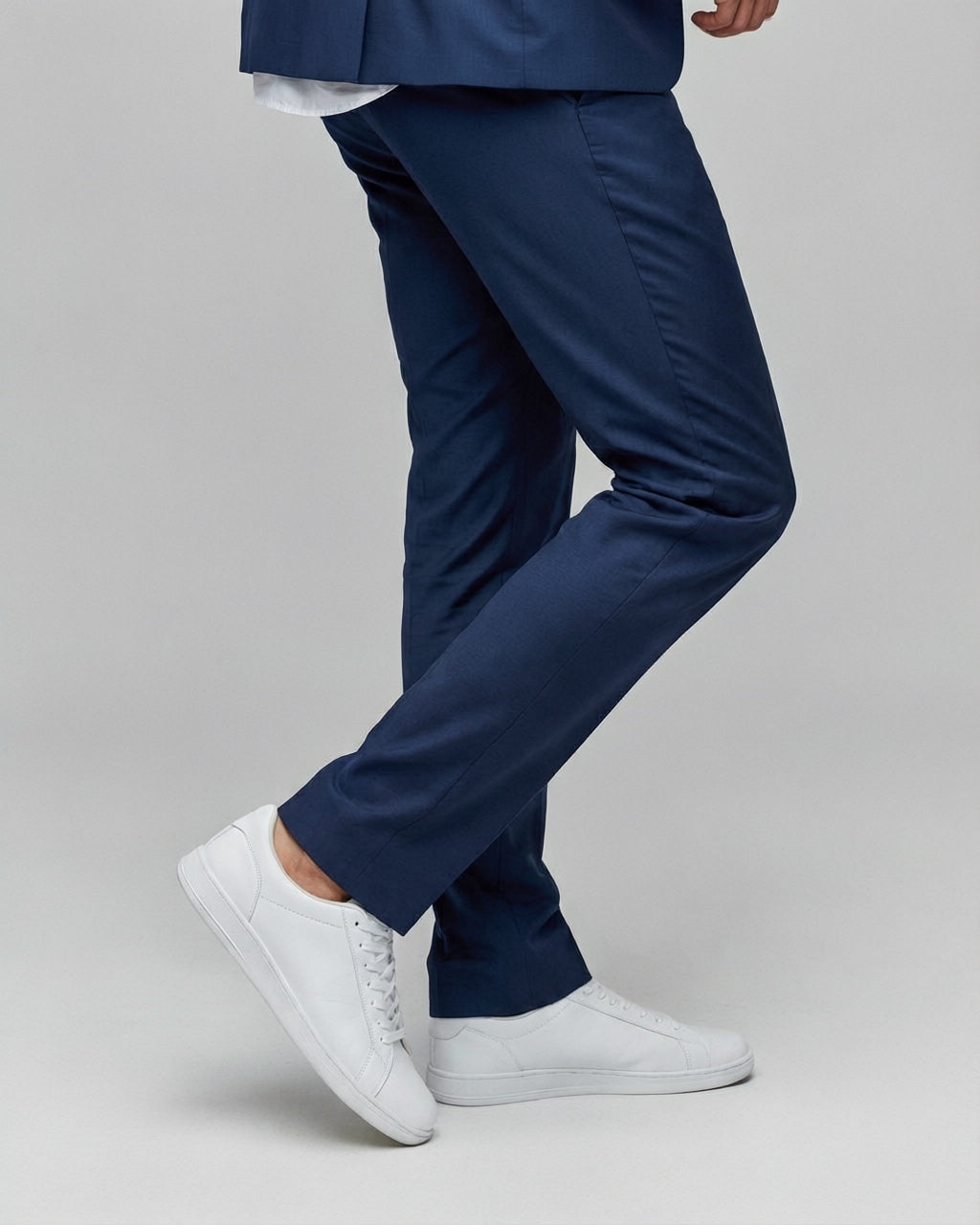 Men's Navy Motion Stretch Suit — trouser fit and hem detail with white sneakers