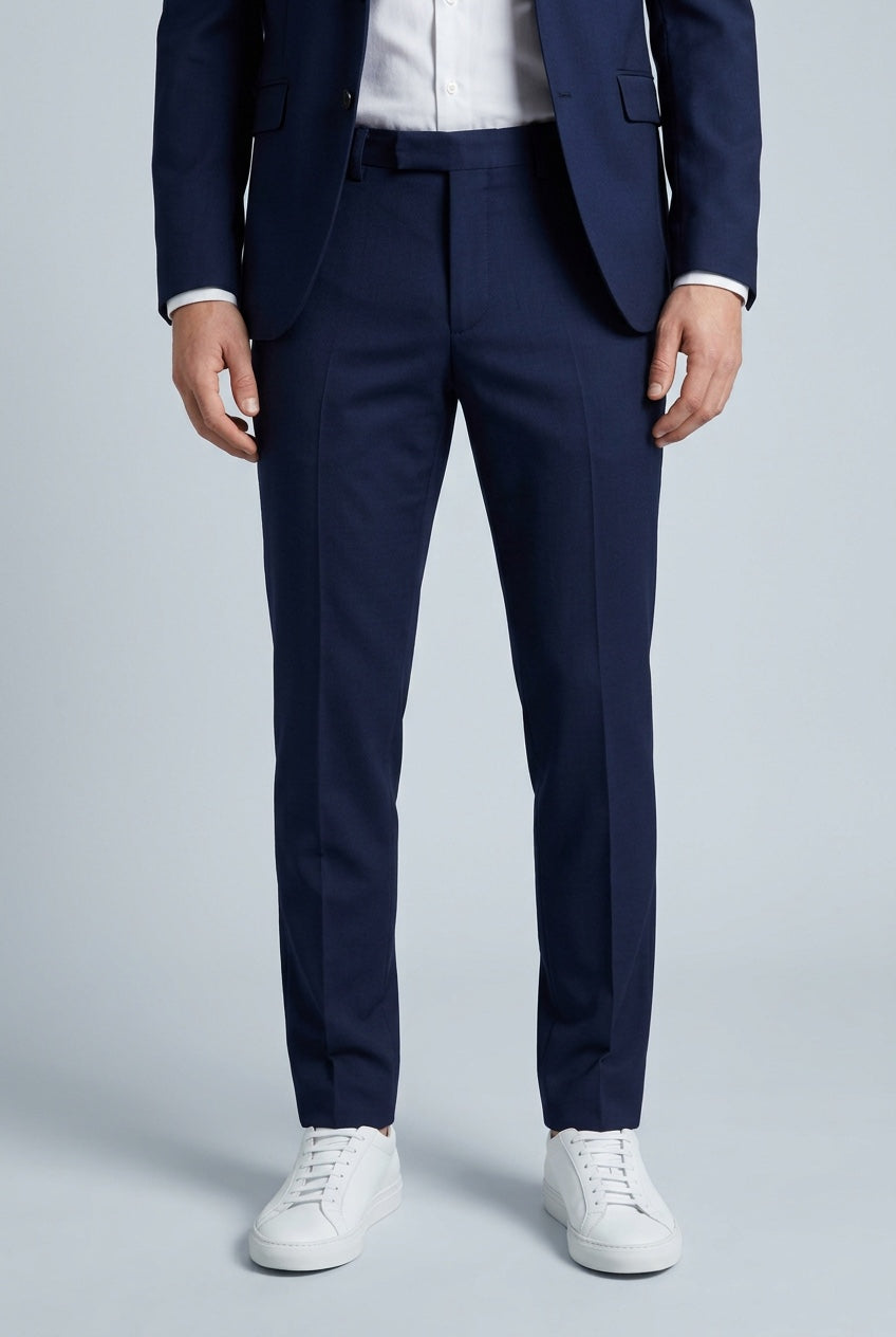 Men's Slim-Fit Stretch Navy Dress Pants — trousers on model, slim-fit leg and hem detail with white sneakers