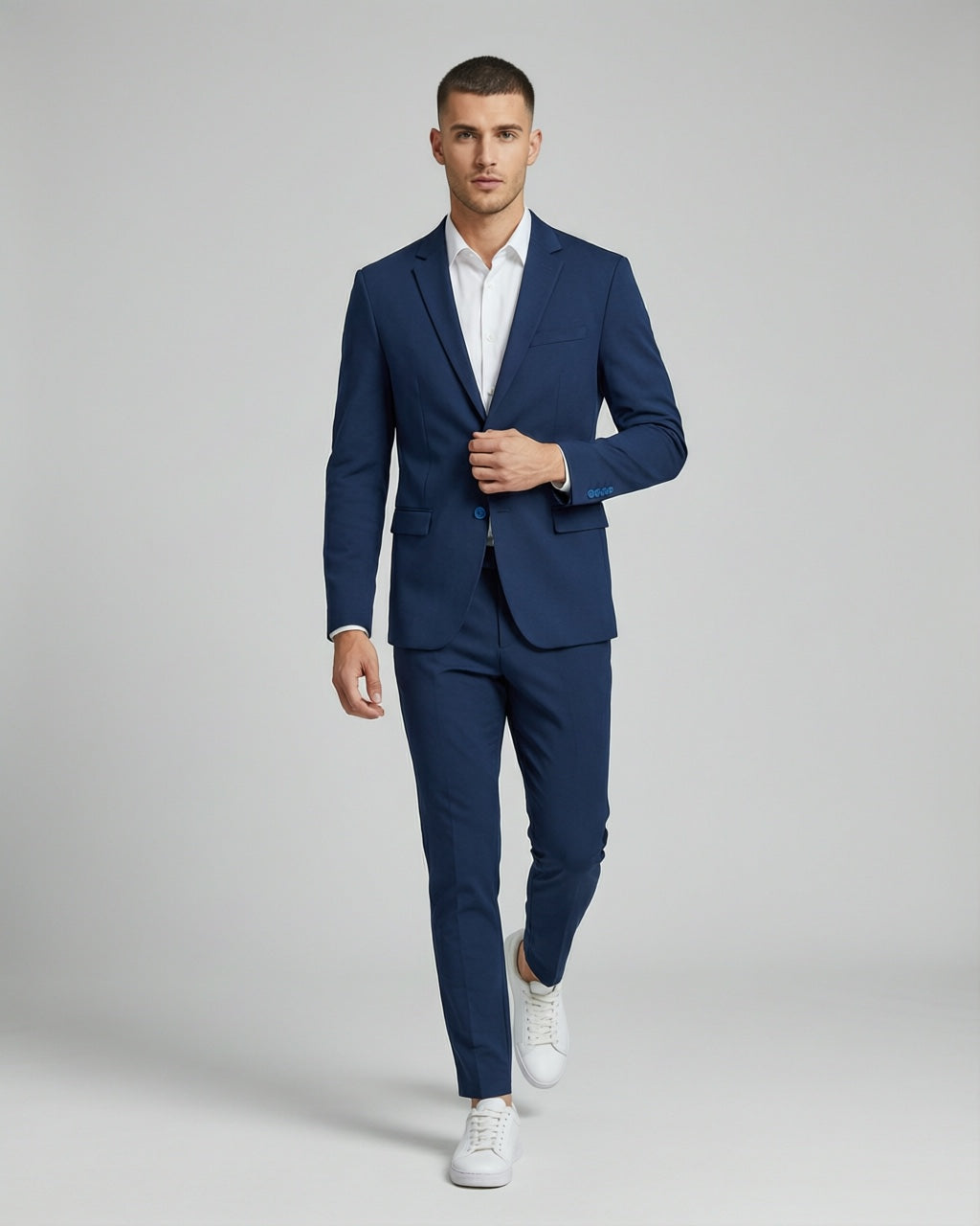 Men's Navy Tailored Stretch Suit — on model with white shirt and white sneakers