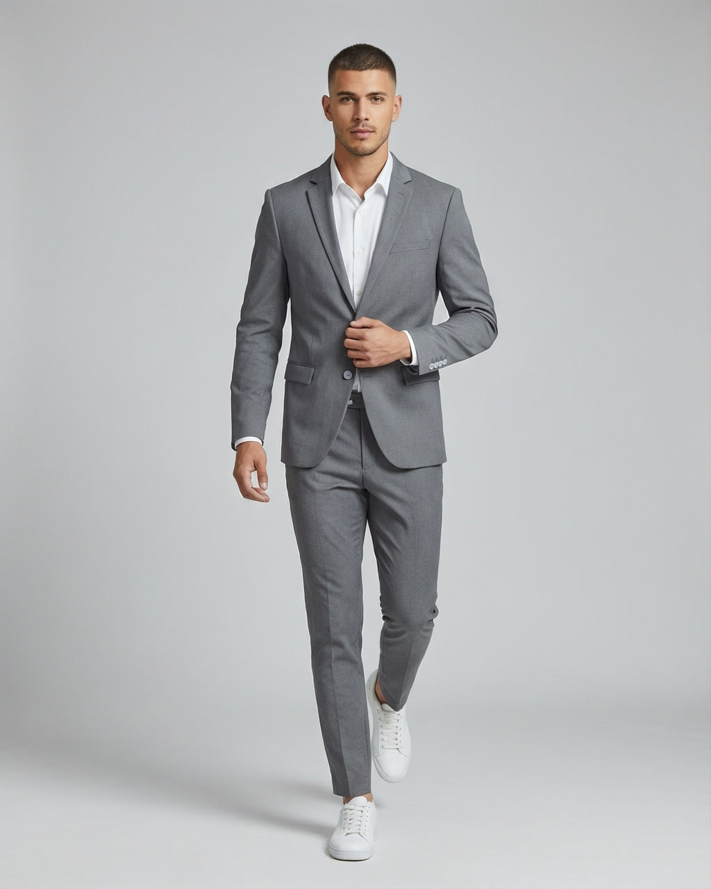 Men's Solid Gray Tailored Stretch Suit — on model with white shirt and white sneakers