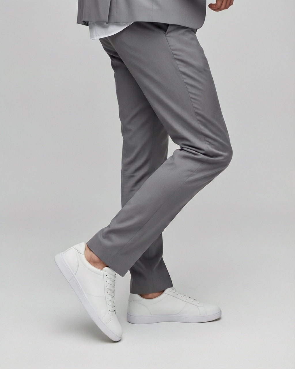 Men's Solid Gray Tailored Stretch Suit — trouser fit and hem detail with white sneakers
