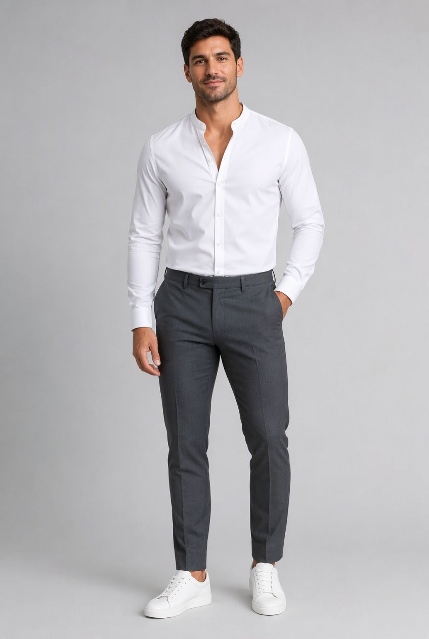Men's White Collarless Stretch Dress Shirt — on model with the top buttons open for a relaxed look, tucked into charcoal trousers with white sneakers