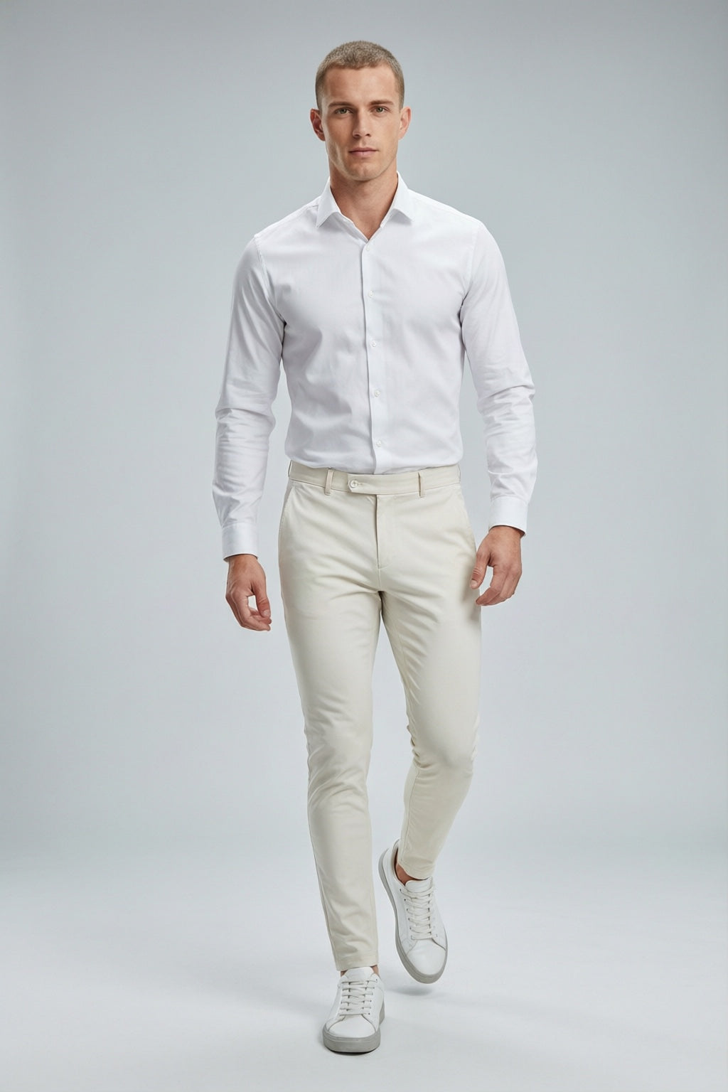 Men's White Motion Stretch Dress Pants — on model with white shirt and white sneakers