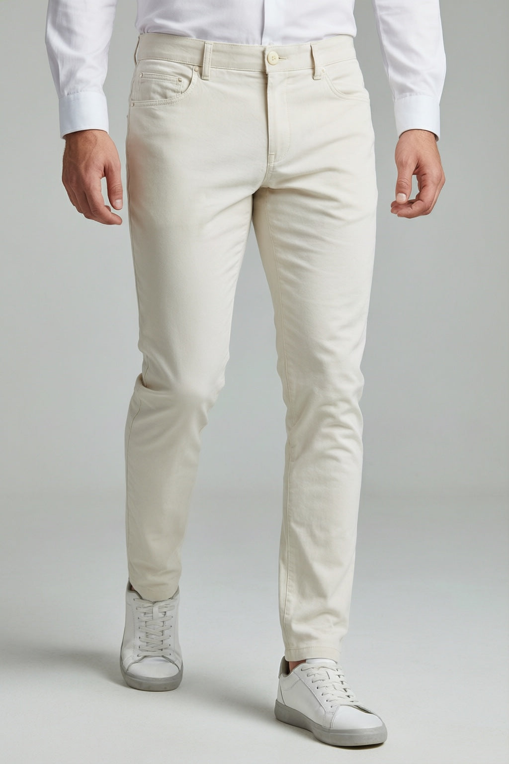 Men's White Motion Stretch Dress Pants — trouser fit and hem detail with white sneakers